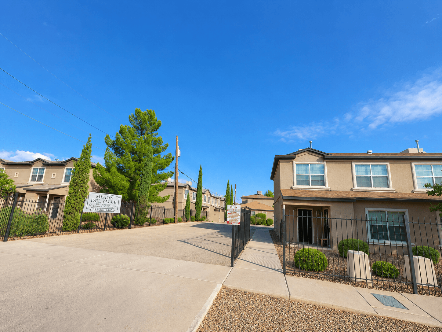 A sunny day at a residential area with a clear blue sky.